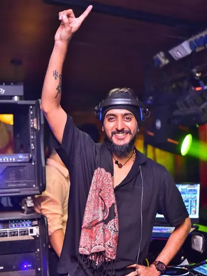 One hand up, celebrating the music. This pose captures the joy and energy I feel during every set.