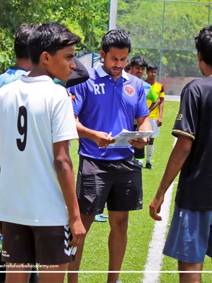 A coach reviewing his notes while speaking to a potential candidate for the Spain camp. Every player gets individual attention as we carefully assess their potential and fit for this high-performance program.