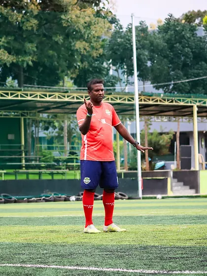 A coach directs his players during a training session. Tactical instruction and clear communication are key components of our preparation for every match.
