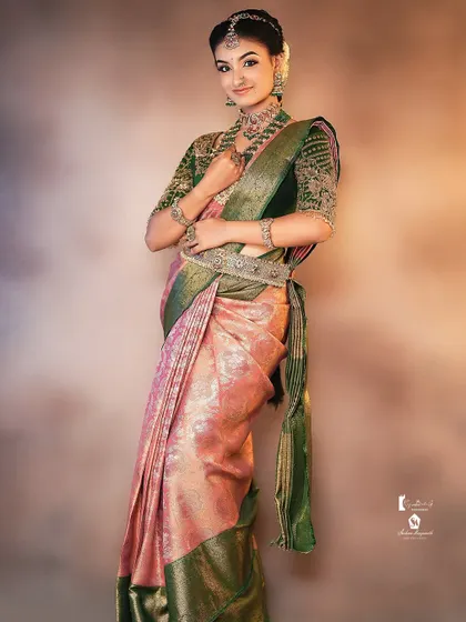 Another angle of this beautiful bridal look, showing the flow of the saree and the placement of the waist belt, or 'vaddanam'.