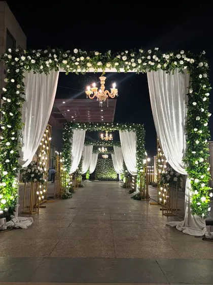 Another perspective of the grand floral entranceway. The layers of arches create a sense of depth and grandeur, making guests feel like they are entering a royal affair.