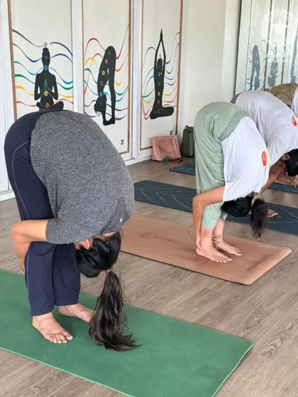 Forward folds like Uttanasana are fundamental for hamstring flexibility. Our TTC students practice this pose to prepare their bodies for more advanced postures.