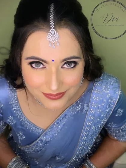 A striking portrait that highlights the bride's beautiful eyes. The makeup is clean and sharp, with well-defined liner and a soft lip, letting her natural beauty shine through. This is modern elegance at its best.