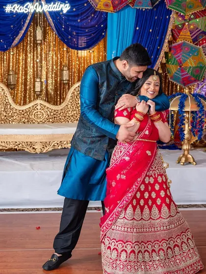 A sweet, candid hug mid-dance, capturing a moment of pure affection between the newly married couple.
