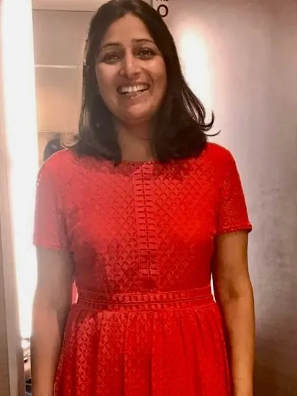 The "after" moment. We introduced her to a vibrant red dress with a defined waistline. The color brings her to life, and the fit celebrates her figure, resulting in a smile that says it all.