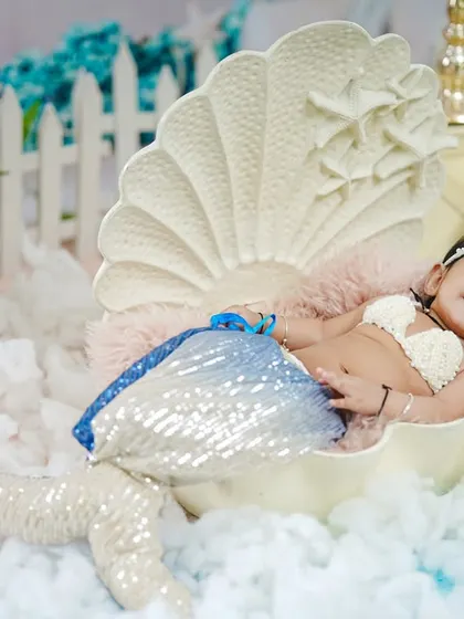 Another angle of the six-month mermaid shoot, capturing her sweet smile and the detailed setup.