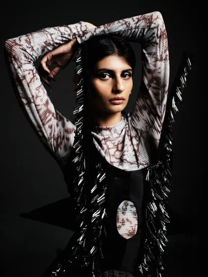A powerful high-fashion look for a designer collection, featuring sharp, dark, winged eyeliner and a sleek, pulled-back hairstyle. The focus is on creating a strong, almost architectural facial structure.