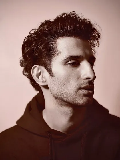 A sepia-toned portrait of Sidhant, giving his modern haircut a timeless, classic feel.