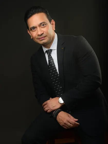 A classic dark-suit portrait that exudes confidence. This is the kind of essential headshot every executive needs for their professional profile.