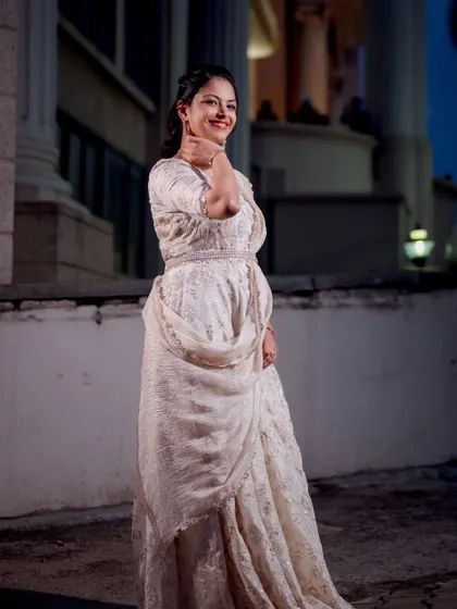 A full-length shot of Shriya's elegant white outfit, paired with a sophisticated makeup look.