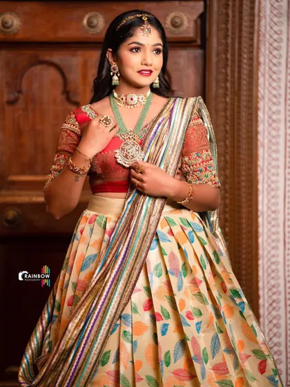Another look at the multi-color half saree, focusing on the texture of the fabric and the rich jewelry.
