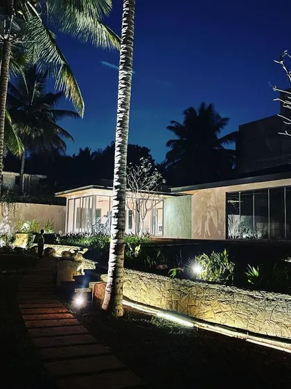 A softly lit pathway guides you through the garden, while the wash of light on the retaining wall adds texture and depth.