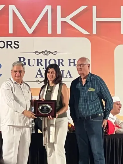Naheed Divecha being presented with an award for her exceptional achievements in Badminton during the Parsi Gymkhana's 140th anniversary celebration.