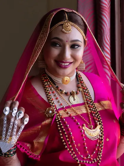 This portrait shows the bride's complete traditional look, including the intricate silver hand jewellery.