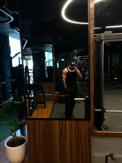 A mirror selfie showing the depth of our gym. The reflection reveals rows of equipment, ensuring you never have to wait to get your workout in.