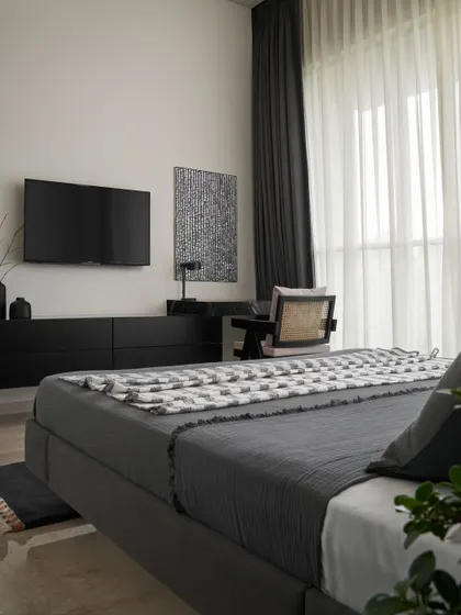 This view showcases the refined material selection in the Slate Bedroom, including matte black glass drawer units and a sleek black Marquina marble study table. These elements create a sophisticated, modern look.