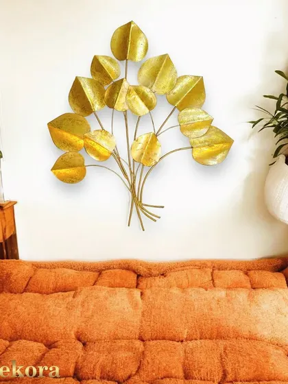 A delicate bouquet of golden leaves, handcrafted from metal to create a light and airy sculpture. This piece is perfect for a bedroom or a cozy reading nook.