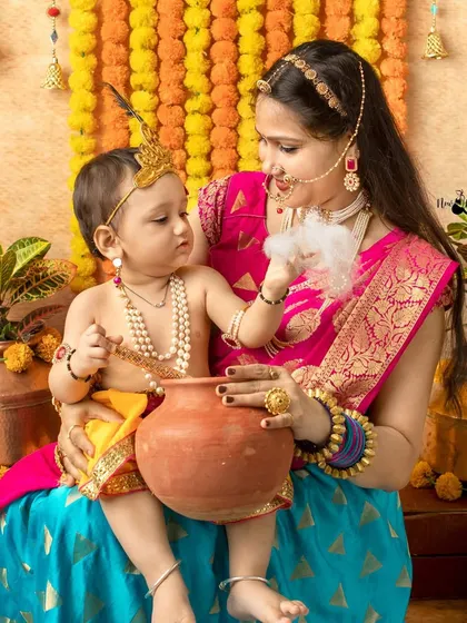 A tender moment between a mother and her baby, recreating the bond of Yashoda and Krishna during a Janmashtami photoshoot.