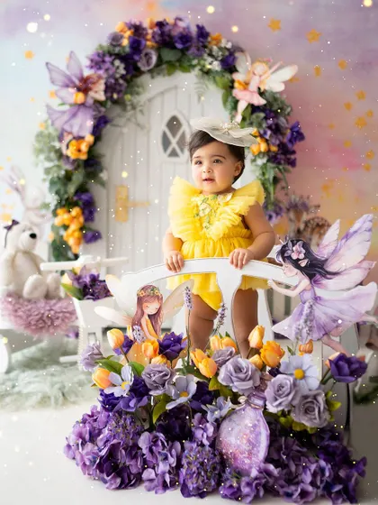 Standing on the bridge in her enchanted forest, surrounded by fairies and flowers.