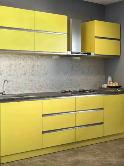 A straight-line modular kitchen in a bright yellow laminate finish. This compact design is perfect for smaller apartments, offering efficient storage without compromising on style.