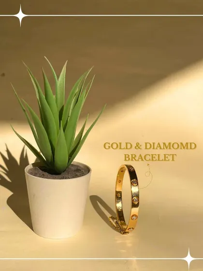 A sleek and modern design, this solid gold bangle is studded with evenly spaced diamonds. Its minimalist aesthetic makes it a versatile piece, perfect for wearing alone for a touch of refinement or for stacking with other bracelets.
