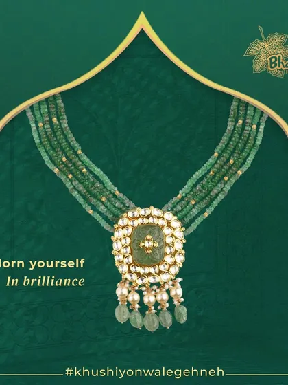 Adorn yourself in brilliance with this elegant necklace. A multi-strand composition of green beads culminates in a central Kundan and pearl pendant, creating a look of pure sophistication.