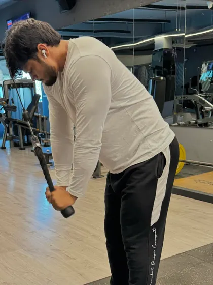 Another shot of the tricep pushdown, showing the proper form and engagement.