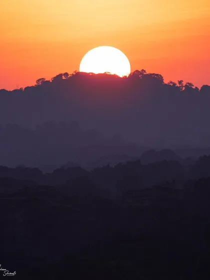 A little different from my usual wildlife photos, this is a minimalist landscape of a sunset in Singapore. The image focuses on the layers of the hills in silhouette and the powerful shape of the sun dipping behind the clouds.