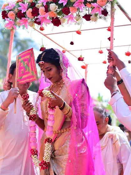 A beautiful moment of the bride's entry under a floral canopy (phoolon ki chadar). We coordinate these traditional moments to ensure they are as beautiful as they are meaningful.
