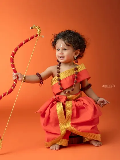 A joyful shot of the young archer. Capturing these happy, energetic moments is what makes these themed photoshoots so special for parents.