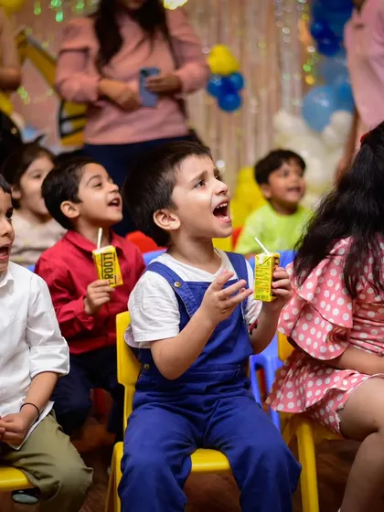 These faces say it all! The kids are singing along, sipping their juice boxes, and having the time of their lives watching the show.