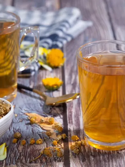 A product shot for a chamomile tea brand. I composed the image with two cups of tea and a bowl of dried chamomile flowers on a rustic wooden surface to evoke a sense of calm and natural wellness.