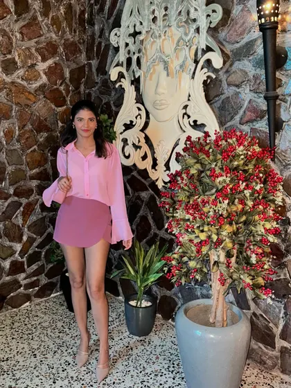 A full-length shot of my pink monochrome outfit. The bell sleeves of the shirt add a bit of drama to the simple silhouette.