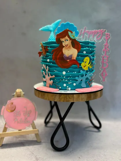 Under the sea with this Little Mermaid cake. I used buttercream to create a wave texture and added edible decorations of Ariel and her friends.