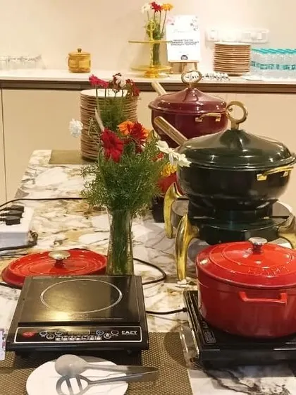 A view of our hot buffet setup, featuring elegant chafing dishes and induction cooktops to keep food at the perfect temperature throughout your event.