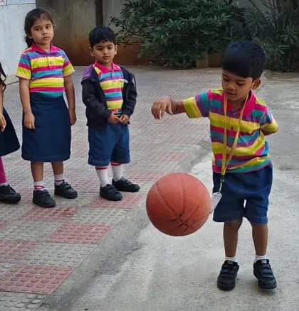 It's all about fun and energy as our preschoolers enjoy a game of basketball during their outdoor playtime.