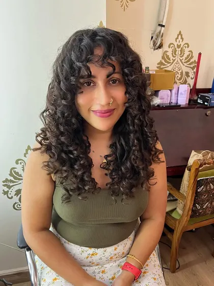 The front view shows how the bangs frame the face and enhance the overall style.