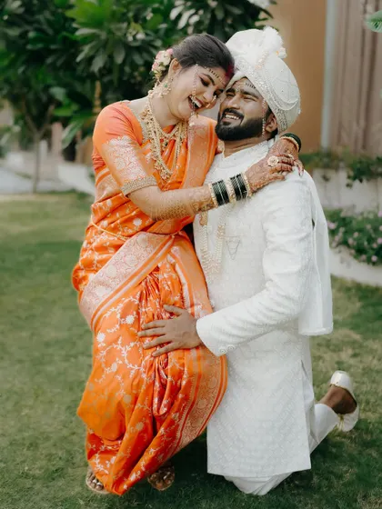 A warm, loving hug. This photo captures the comfort and happiness the couple finds in each other, with their traditional outfits adding a layer of cultural beauty.