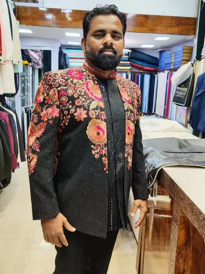 Another view of the black Indo-Western suit with floral embroidery, showing the detail and craftsmanship that goes into each piece.