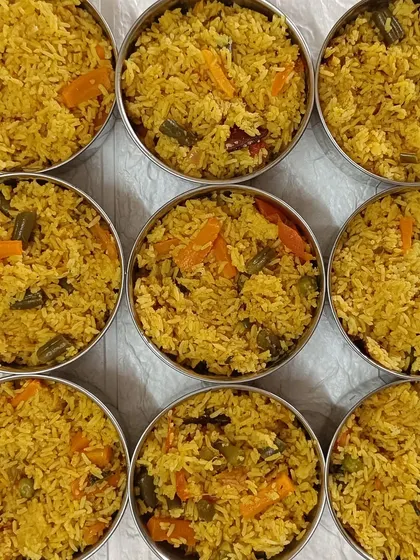 A top-down view of my Veg Pulao, portioned out and ready for delivery. You can see the colorful mix of vegetables and the beautiful yellow hue from the turmeric and spices.
