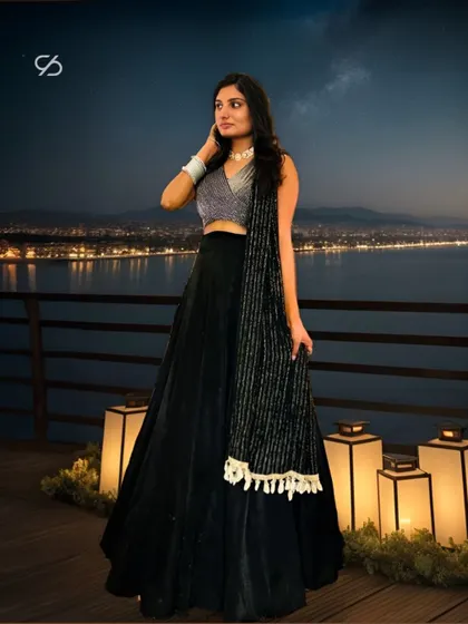 My client steals the spotlight in her custom black lehenga, set against a beautiful nightscape. The shimmering blouse and flowing velvet skirt create a look of pure enchantment.