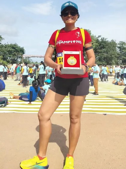 Holding my winner's trophy from the JSW Steel City Run. A first-place finish in my age category and a reminder to keep pushing despite age and perimenopause.