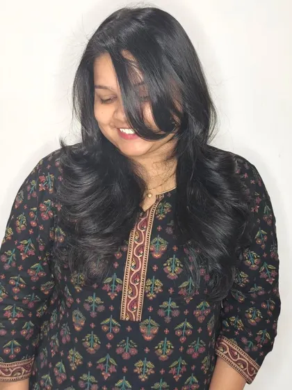 A playful and happy photo showcasing the beautiful movement in her new layered haircut.