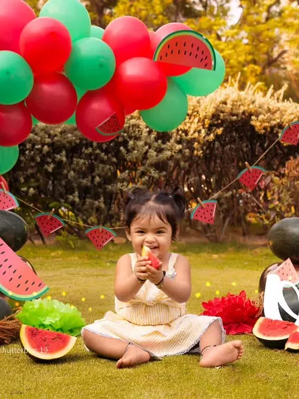 This little one is enjoying a slice of watermelon, a cute and candid moment from her outdoor birthday session.