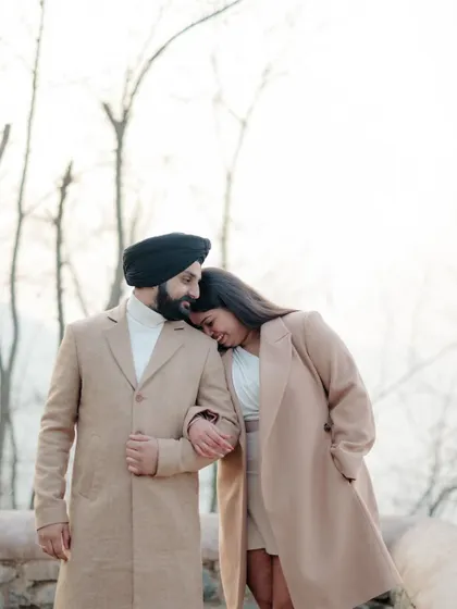 A sweet and tender moment with the beautiful, bare trees of Kashmir creating a serene and romantic backdrop.