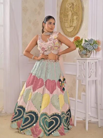 A playful and colorful lehenga with a heart-patterned skirt in pastel shades. This is a unique and fun choice for a Mehndi or carnival-themed event.