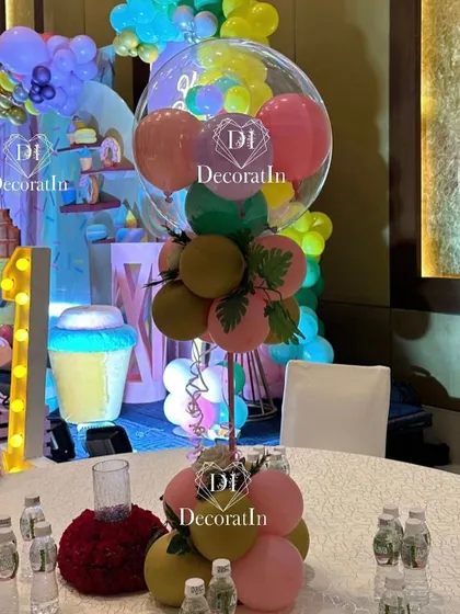 A creative and colorful table centerpiece made of balloons, designed to look like a sweet treat, perfect for the Candyland theme.