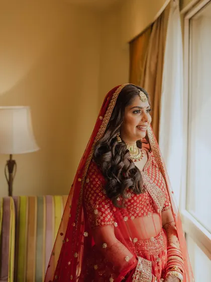 Another beautiful window shot, capturing her excitement. The makeup looks fresh and radiant.