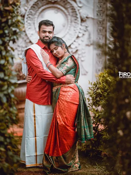 A tender embrace in a garden setting. The couple's traditional outfits and the soft, natural light create a very romantic and intimate pre-wedding photo.
