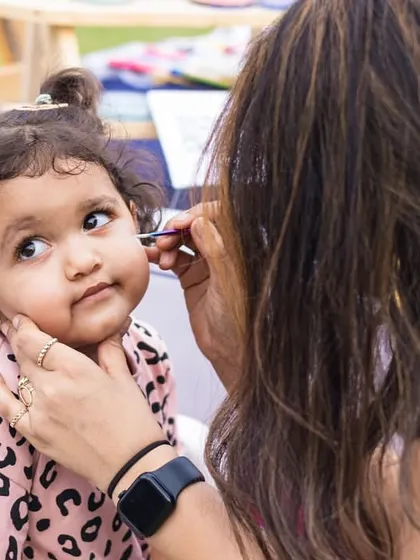 The process of painting a tiny unicorn on a tiny cheek. We use steady hands and a gentle touch.